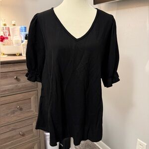 Black, with cuffed sleeve.  Never worn